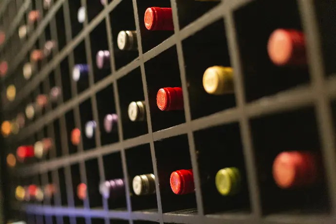 red green and yellow beads on white metal fence